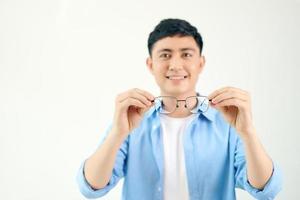 cheerful man holding glasses in front of him on a white background photo