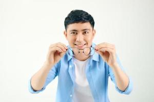 handsome man holding glasses before his eyes photo