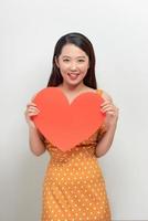 Young woman with red heart isolated on white background photo