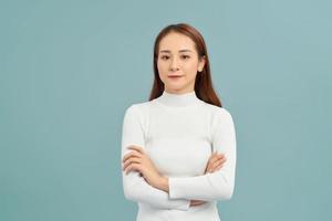 Laighing woman with crossed arms looking at the camera over white background photo