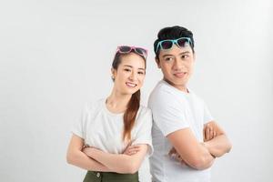 emotions and people concept - portrait of happy couple in white t-shirts celebrating success over white background photo
