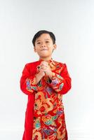 Cute little Vietnamese boy in ao dai dress smiling. Tet Holiday photo