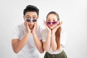 Close-up portrait of two nice attractive adorable cheerful people husband wife in eyeglasses eyewear touches cheeks with both hands over white background photo