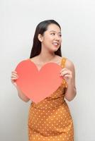 color vertical image of a girl on white with a big red heart photo