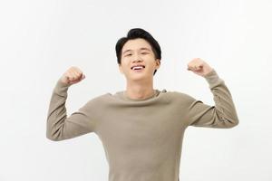 A portrait of happy excited young Asian man isolated on white background photo