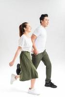 smiling boyfriend and attractive girlfriend in casual clothes holding hands photo