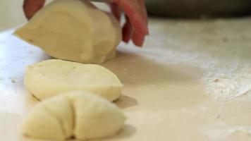 A woman cooks pies at home. Cooking and baking at home. Preparing dough for baking. Test batch. A woman prepares fried yeast dough pies in a home kitchen. Handmade food preparation concept. video