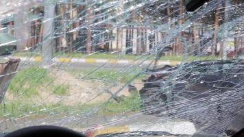 Cracked car windshield after an accident. Close-up of a wrecked vehicle after a collision with a pedestrian or car accident. Damaged vehicle. Road safety, car insurance. View from inside the cabin. video