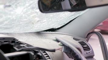 Cracked car windshield after an accident. Close-up of a wrecked vehicle after a collision with a pedestrian or car accident. Damaged vehicle. Road safety, car insurance. View from inside the cabin. video