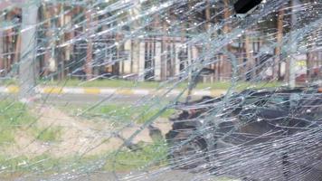 Cracked car windshield after an accident. Close-up of a wrecked vehicle after a collision with a pedestrian or car accident. Damaged vehicle. Road safety, car insurance. View from inside the cabin. video