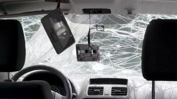 Cracked car windshield after an accident. Close-up of a wrecked vehicle after a collision with a pedestrian or car accident. Damaged vehicle. Road safety, car insurance. View from inside the cabin. video