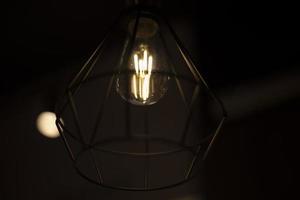 Lamp in dark. Lamp in night. Incandescent lamp. photo