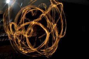 Circles of fire. Lines of flame. Shooting fire show on long shutter speed. photo