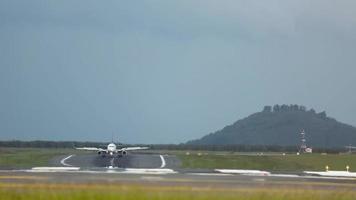 Jet airplane slows down after landing. Front view, plane braking, arrival video
