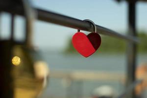 Heart lock is fixed to handrail. Wedding symbol. Wedding details. photo