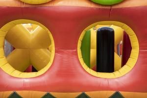 Inflated obstacle course. Rubber trampoline. Entertainment area in summer. photo