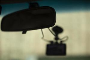 Interior of car. Rear-view mirror in cabin. DVR on glass. photo