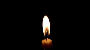 Close-up of the flame burning on the candle with isolated on a black background. Candle flame in the dark. video