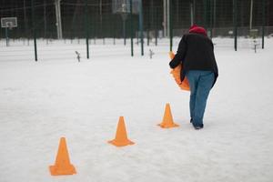 Installation of signal tubes. Orange caps on road. Sports equipment for precision movement. Marking of territory. photo