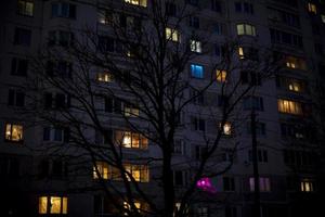 Light of windows of house. Apartment lights. photo