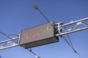 Traffic sign over road. Screen on track. Electronic scoreboard with signs for drivers. photo