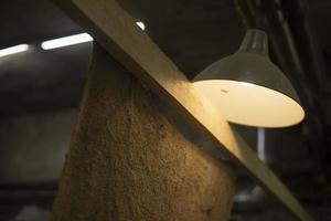 Lamp shines indoors. Interior in garage. Classic light source. photo