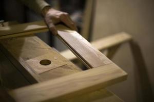 Carpenter makes wood. Board processing. photo