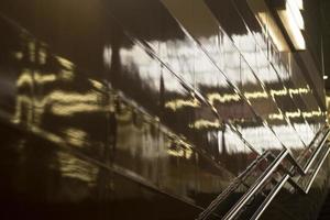 Reflection in wall of light. Handrail for climbing stairs. photo