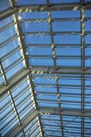 Glass roof in shopping mall. Details of interior in building. Light through glass. Dome in building. photo