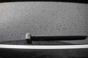 Wet car window. Rear window of transport. Drops on car. photo