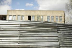 Steel fence and abandoned building. Details of ghetto. photo