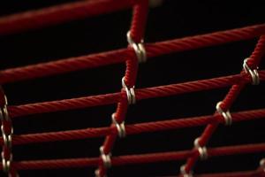 Ropes in the playground. Climbing net, shot close-up. Ropes fastened with links. photo