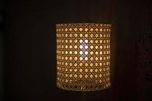 Lamp made of wood. Light through grid. Design of lighting equipment. photo