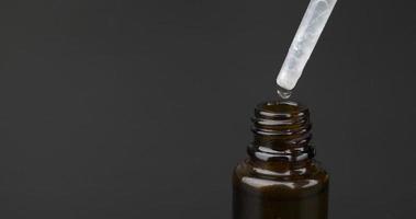 pipette cannabis oil extract drop dripping in bottle copy space on dark background video