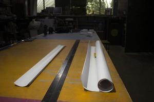 Roll of paper. Cutting film. Big lineup. Table in advertising workshop. photo