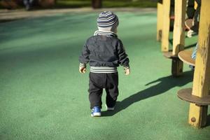 Child on playground. Small walks outside. Walk with child. photo