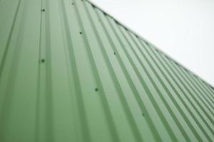 Green steel wall. Details of cladding of building. photo
