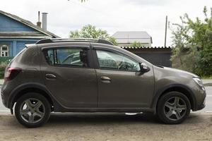 Car is parked in countryside. Family transport outside city. Car is on side. photo