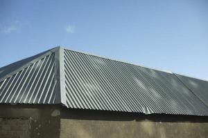 Stainless steel roof. Steel roof of house. Small building. photo