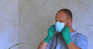 A man with a beard in a doctor's suit puts on a mask video