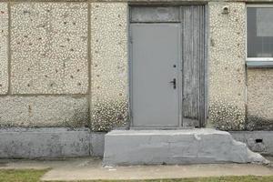 Door to building. Emergency exit from school. Grey door. photo