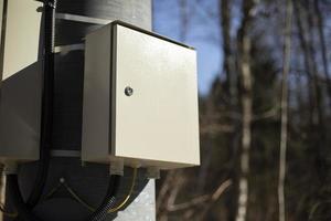 Box of wires. Electrical equipment on pole. photo