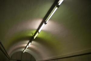 Lamps on ceiling of tunnel. Details of interior of metro. photo