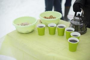 Tea in glasses outside. Kitchen for those in need. Distribution of food. Drinks for homeless. photo