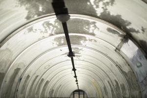 Tunnel made of plastic. Snow on dome. Outgoing perspective. photo
