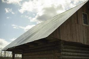 Old roof of building. House in village. Roof of house. photo