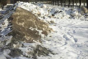 Snow removed from road. Pile of snow outside. photo