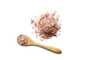 Pink Himalayan organic salt in an eco-friendly little wooden spoon top view, isolated object, healthy dieting photo