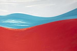 Textured fabric in wind. Flag of Russia fabric. Wind blowing on surface of light fabric. photo