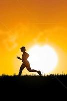 people jogging in the meadow in the evening photo